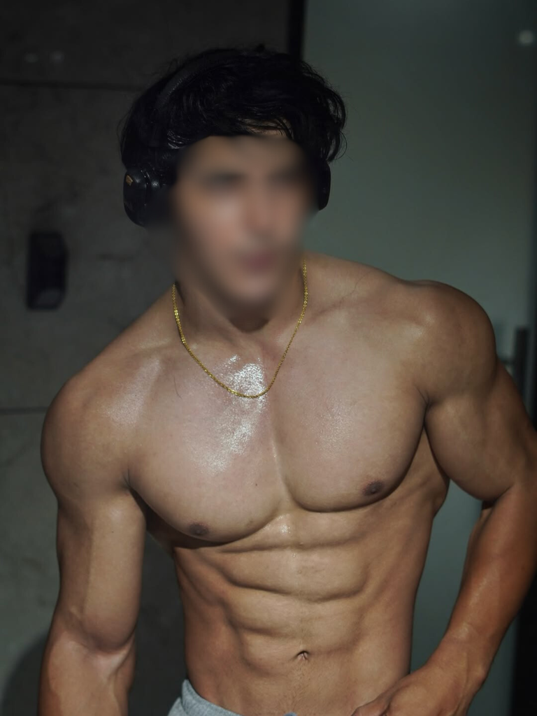 Tall muscular male escort profile image with warm charm